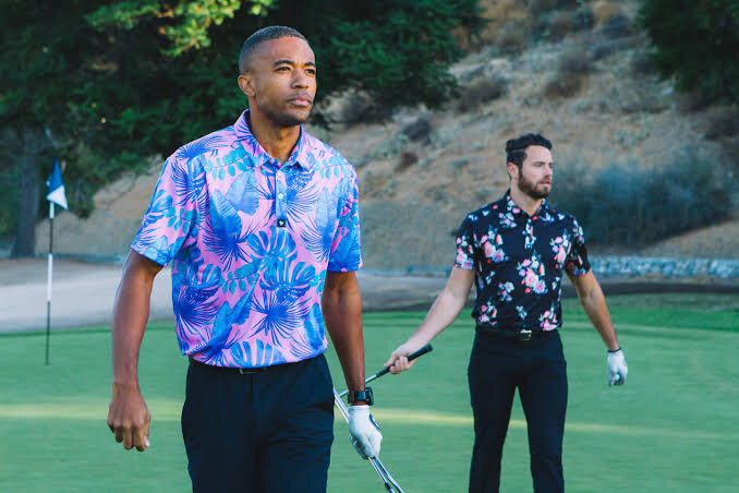 Two golfers wearing bold Bad Birdie printed polos on a golf course