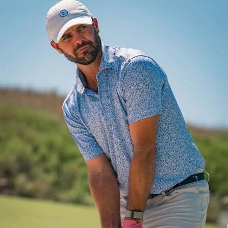 Golfer wearing a blue patterned Rhoback performance polo