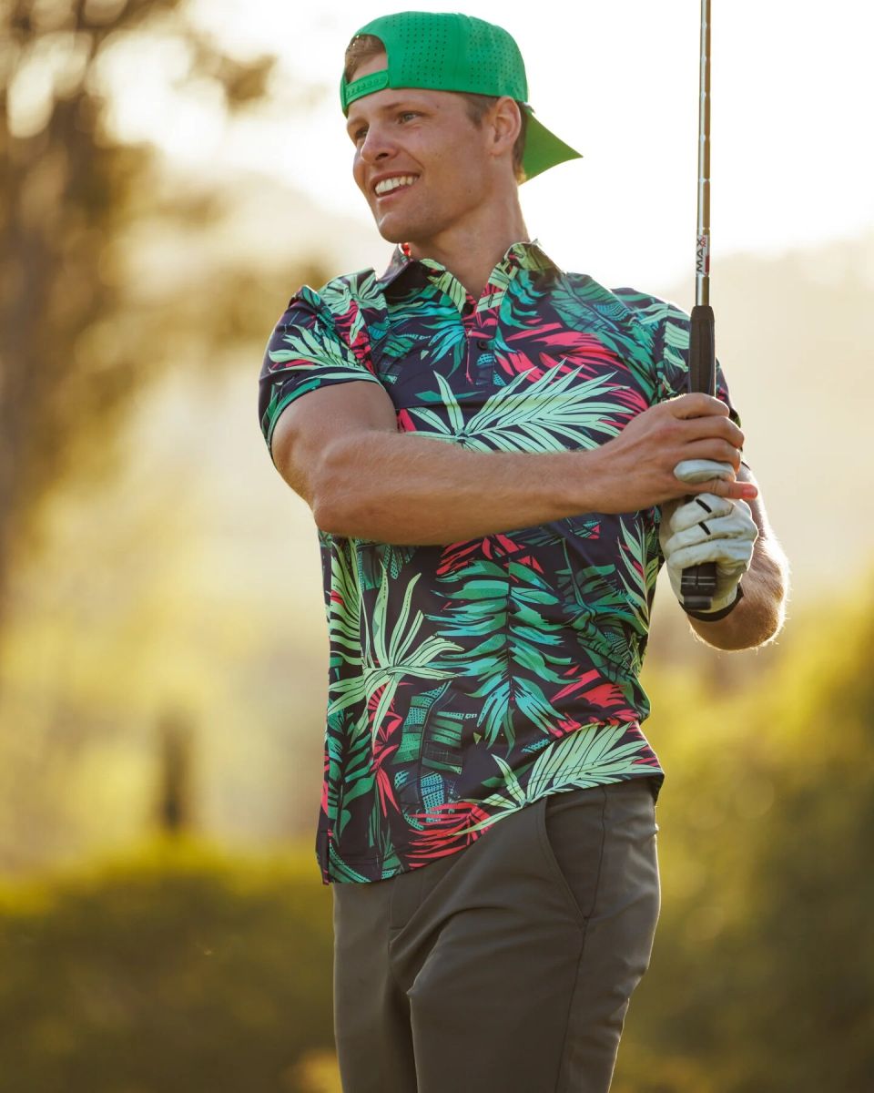 Sunday Swagger golfer wearing a dark tropical leaf print polo