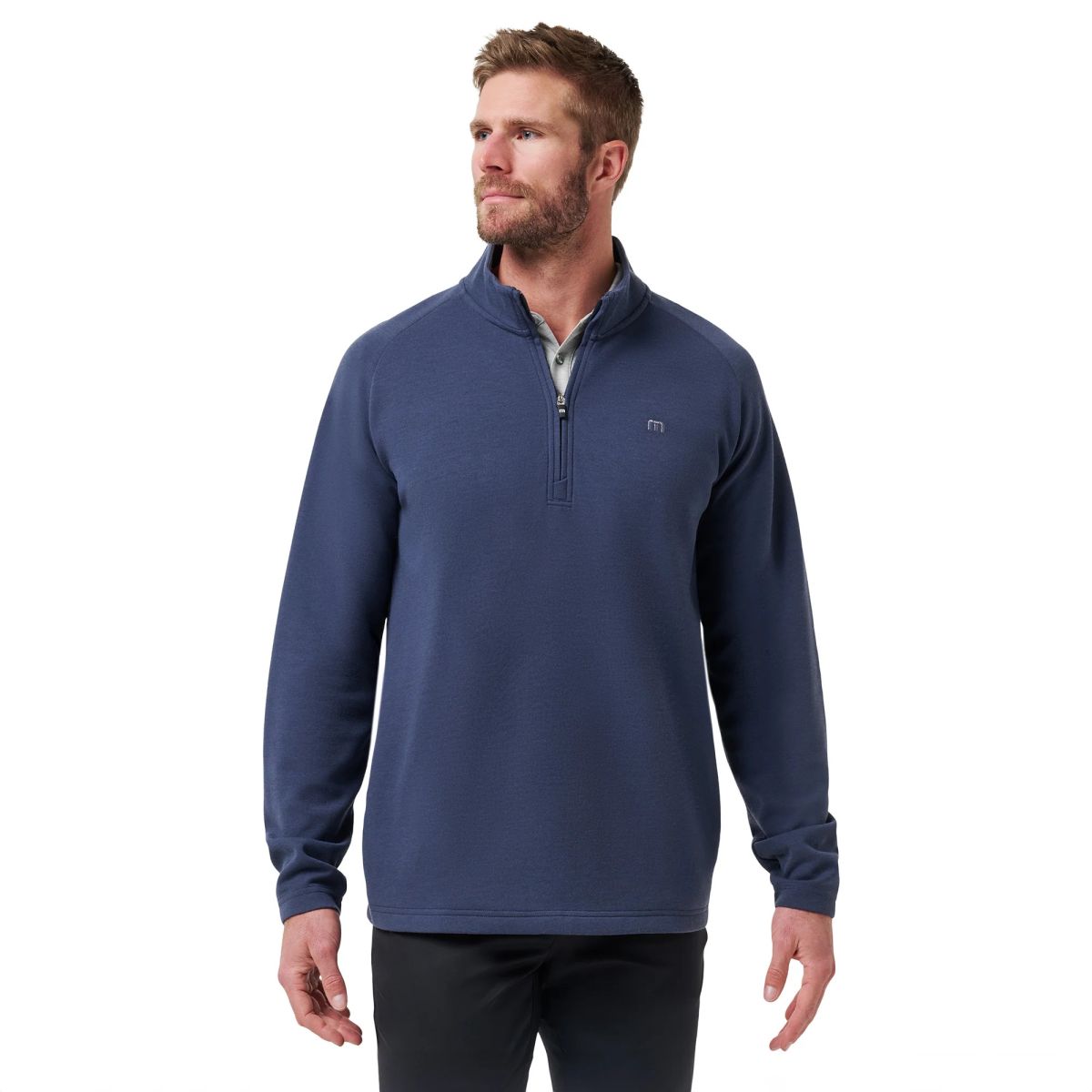 Man wearing a navy TravisMathew quarter-zip