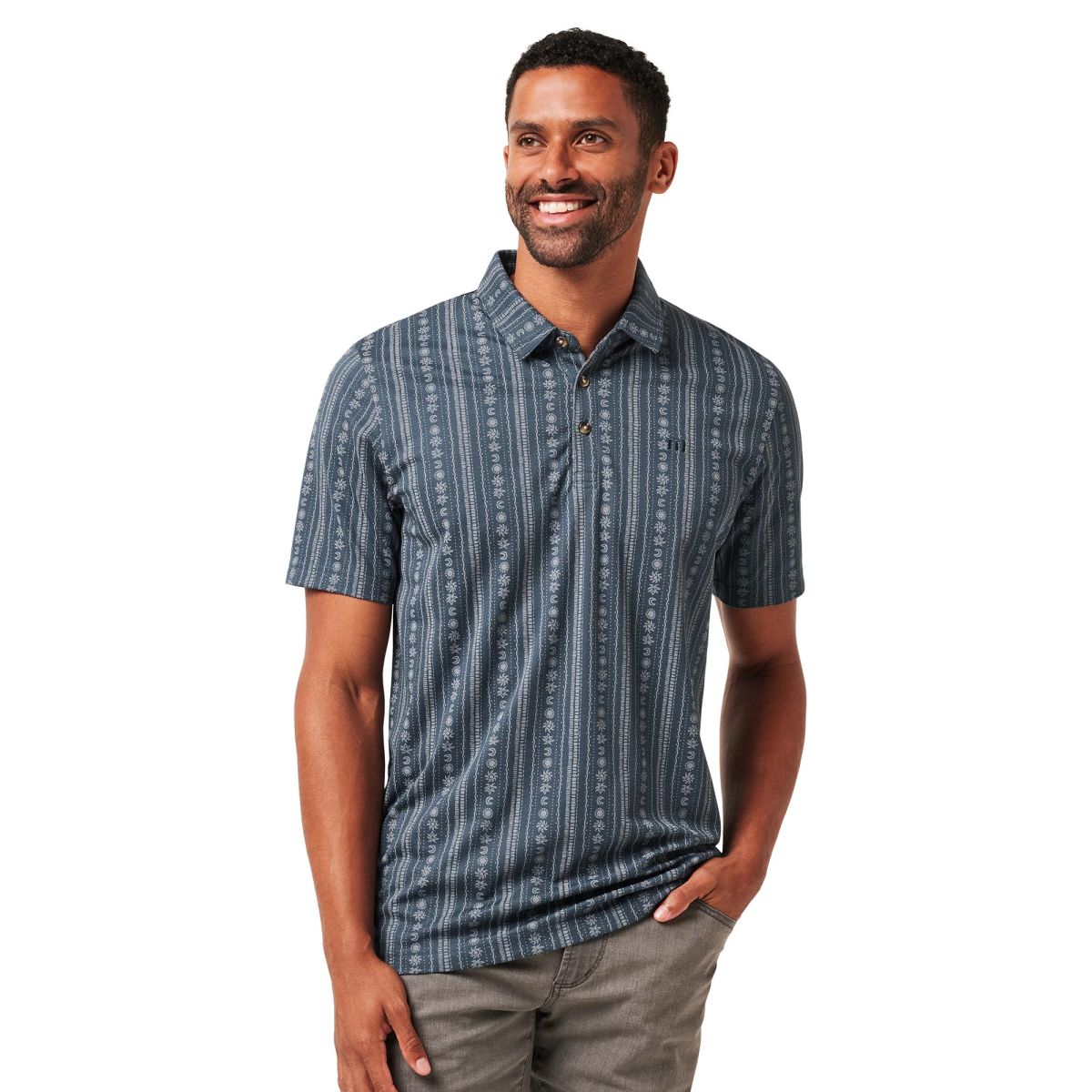 Man wearing a dark patterned TravisMathew polo