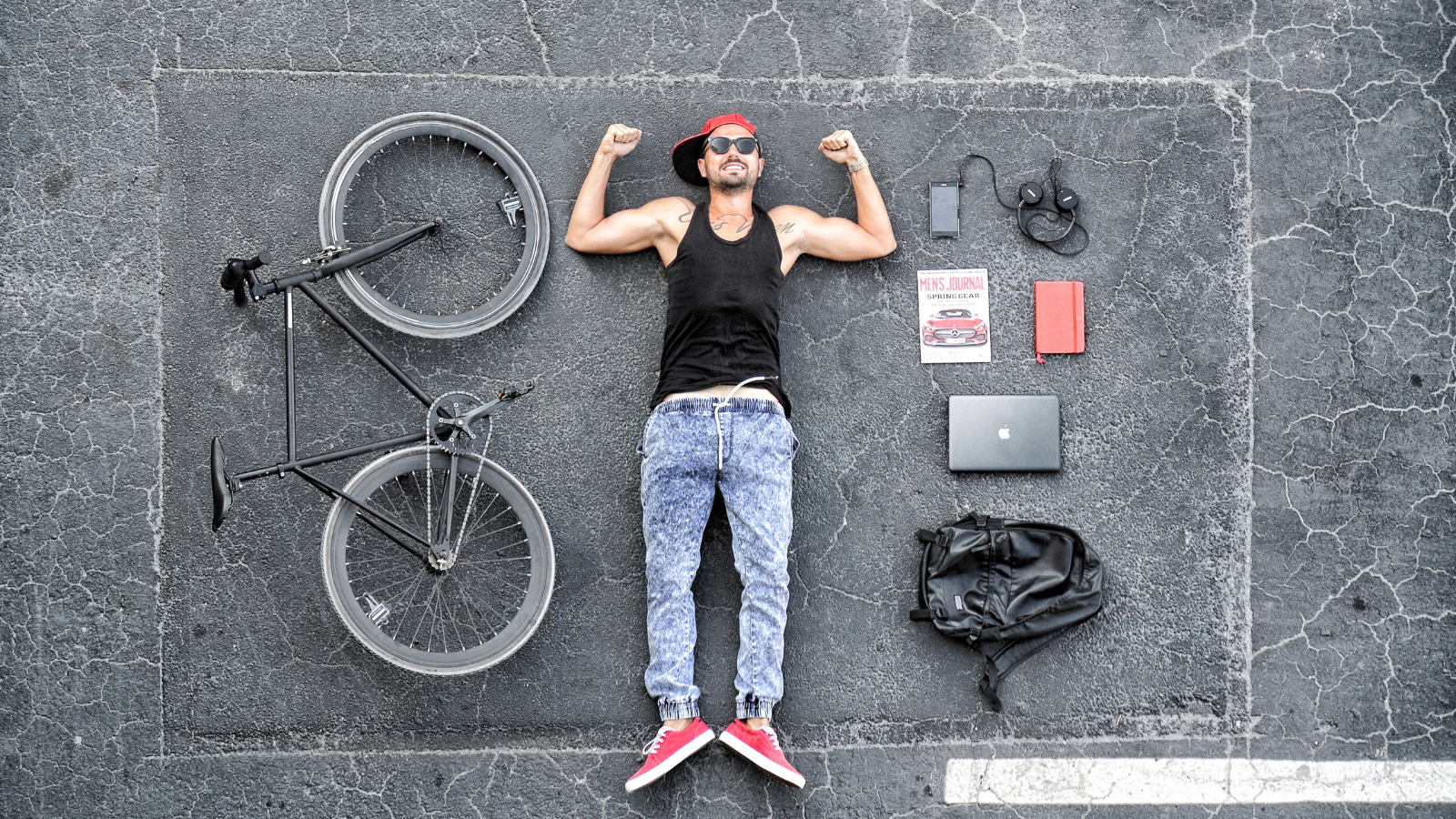 Dron Shot of Man Lying on the Floor Next to a Bike