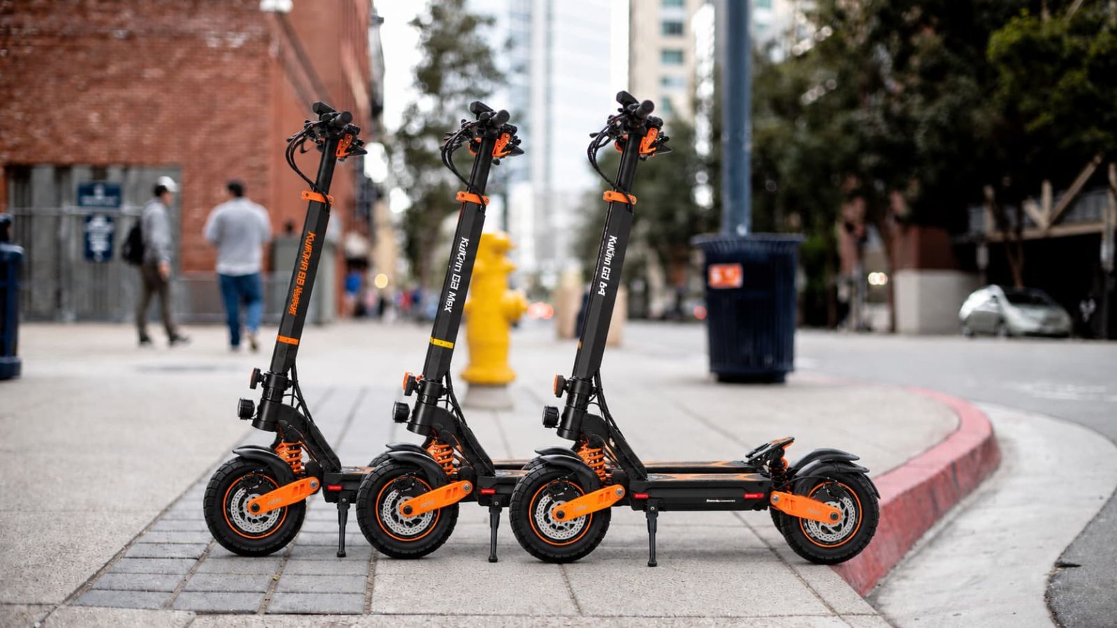 KuKirin G2 Master, G2 Max and G4 electric scooters beside an urban riverside and trail